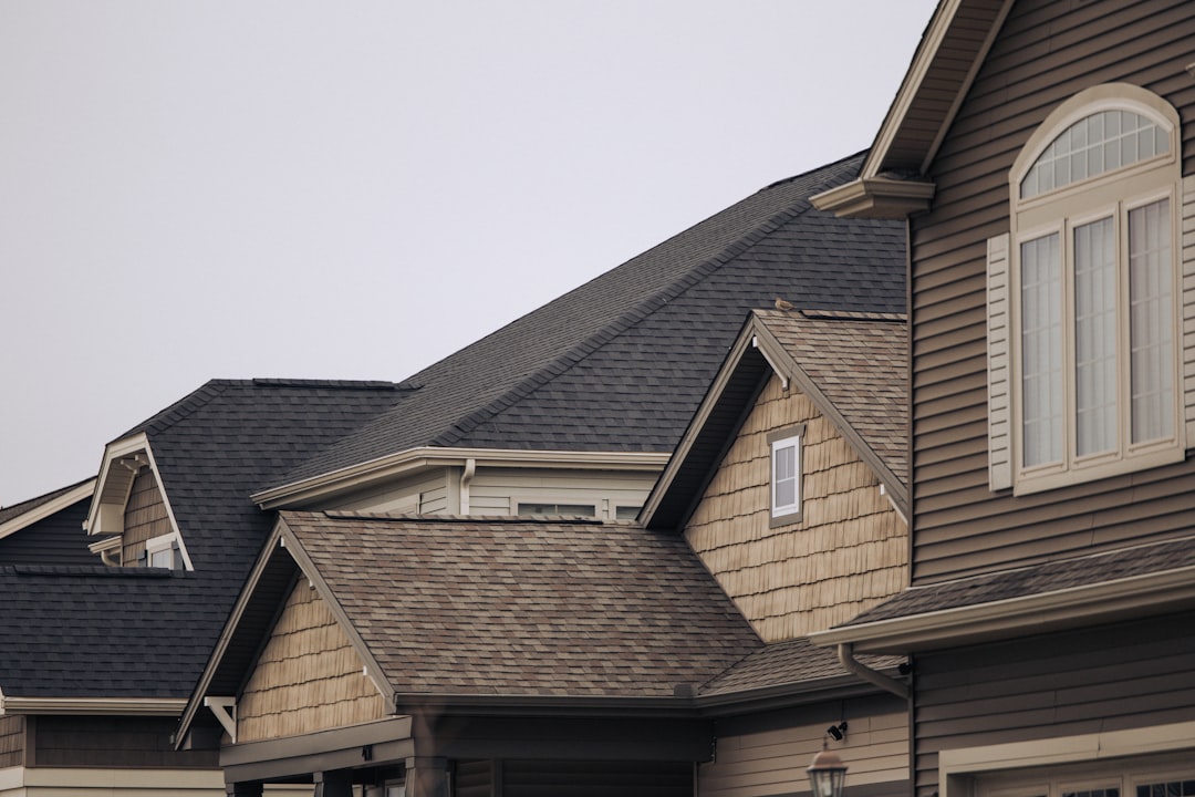 Home exterior with shingle siding and white trim windows