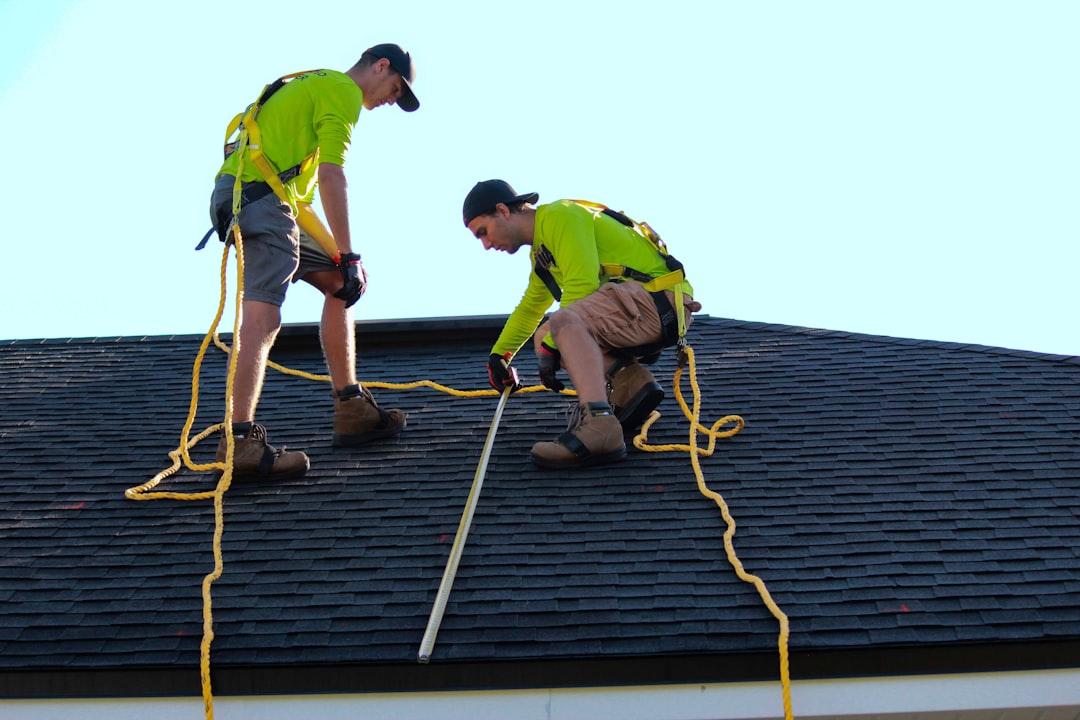 Roofing crew installing shingles